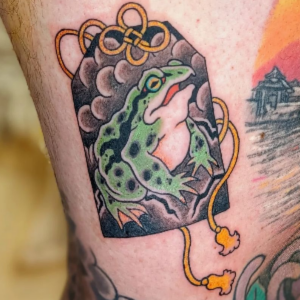 frog omamori tattoo